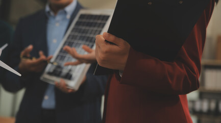 Poster - Close-up at tablet, Engineers pointing at tablet with their hands. To jointly design the use of renewable energy with wind and solar energy. Concept of using renewable energy.