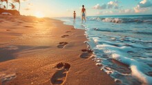 A pair of footprints in the sand near the water at sunset, beach, summer, travel, journey or adventure