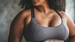 © Radomir Jovanovic - Close-up image focused on a confident woman personifying strength and healthy lifestyle, depicted in a sports bra