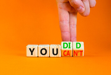 Poster - You can not or did it symbol. Concept word You did or You can not on beautiful wooden cubes. Beautiful orange background. Businessman hand. Business and you did or can not concept. Copy space.