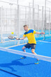 © Mike Orlov - Open Tour template. Padel tennis player on the blue court background outdoors. Paddle tenis template for bookmaker design ads with copy space. Mockup for betting advertisement. Sports betting on tenis