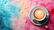 a cup of cappuccino on a saucer with a spoon on a pink, blue, and pink background.