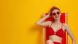 © tiena - Studio photo of a beautiful girl in a red swimsuit and sunglasses on a yellow background with space for text. AI generative