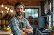 © svastix - A suave male chef with crossed arms in a modern, well-equipped kitchen