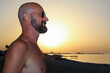 © Luciano Spinelli/Stocksy - Profile portrait of an Italian man with sun glasses during sea sunset