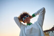 © Boris Jovanovic/Stocksy - Happy woman tightens her hair