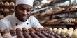 AskilledAfricanAmericanchocolatierexpertlycraftshomemadechocolatesathome. Concept Homemade Chocolates, Skilled Craftsmanship, Chocolate Making, African American Expert, Artisan Chocolatier