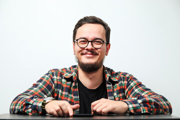 portrait of young smiling caucasian man on white background. man wearing eyeglasses, watch and casua