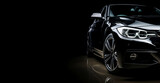 Fototapeta Nowy Jork - Black generic and unbranded sport car isolated on a black background with copyspace