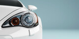 Fototapeta Miasta - Closeup on a generic and unbranded white car on a light blue background