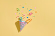 © Marc Tran/Stocksy - birthday hat with confetti on paper background