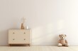 Empty wall mock up with a small beige cabinet and cuddly toy