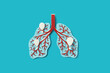 © Yaroslav Danylchenko/Stocksy - Papercraft infected human lungs with balloons over blue background