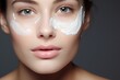 woman applying face cream on face closeup. Skincare cosmetics