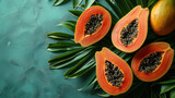 ripe papaya fruit cut in half on a backdrop of tropical leaves