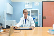 © Raul Navarro/Stocksy - smiling female doctor at the doctor's office