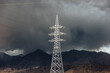 © Heng Yu/Stocksy - Electricity Pylons Against Stormy Mountain Backdrop