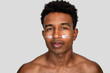 © nomad studio/Stocksy - Man with moisturizer cream on face.