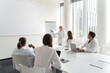 © Hernandez & Sorokina/Stocksy - Meeting Of Researchers In Modern Conference Room