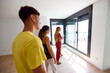 © Javier Díez/Stocksy - Female realtor introducing apartment to young couple