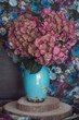 Beautiful purple hydrangea flowers in a vase on a table.Delicate floral arrangement. Close-up floral composition with a pink spring flowers. Soft focus.
