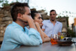 © Pixel Stories/Stocksy - Group of friends chatting at a cafe/bar and having cocktails