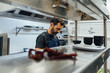 © Alberto Rojas/Stocksy - Male chef preparing food in kitchen