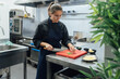 © Alberto Rojas/Stocksy - Woman cutting vegetables in restaurant