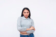 A young Asian woman with a resting bitch face. Isolated on a white background.