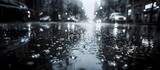 Fototapeta  - Rainy Street Reflections in Black and White, To provide an evocative and dramatic background for a video or website, conveying a sense of solitude,