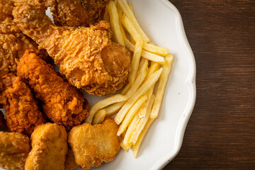 Sticker - fried chicken with french fries and nuggets on plate