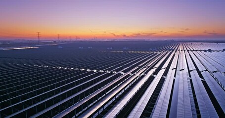 Wall Mural - Aerial video of solar panel scene at dusk, green energy concept. Photovoltaic power station on water. Drone surround shooting.