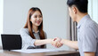 © MD NAZMUL HASAN - Sell agent, success deal Asian young woman handshake or shaking hands with landlord realtor, client male after buyer man signed rental, lease contract. Banker agreement mortgage loan, property lease.