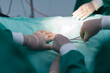 surgeon operating on patient in operating room close up, surgical operation. Busy surgeons passing scissors to each other during an operation