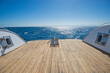 Ladders on the back wooden deck of a luxury motor yacht
