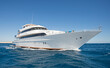 Luxury private motor yacht under way sailing at sea