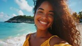 Fototapeta Uliczki - Young woman enjoying vacation taking selfie on tropical beach with clear blue sky and lush island in background. Summer travel and leisure.