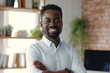 © Ishra - Portrait of a handsome smiling African American businessman at office workplace, professional confident looking senior business man at office, positive looking executive manager wearing casual shirt