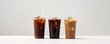 Three cups of iced coffee mockup with colorful straws on a white background.