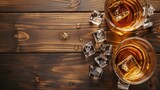 Fototapeta Perspektywa 3d - Whiskey with ice on a wooden table, viewed from above.
