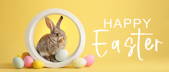 Wall Mural - Happy easter feast concept holiday celebration greeting card with text - Cool easter bunny, rabbit with many colorful painted easter eggs, sitting, isolated on yellow  background..