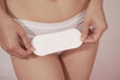 woman wearing underwear White holds a menstrual sanitary napkin. white background