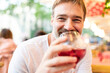 Joyful man enjoying a glass of wine at a restaurant in Barcelona