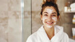 © Александр Довянский - happy caucasian young woman uses facial skin care cream in the bathroom. copy space