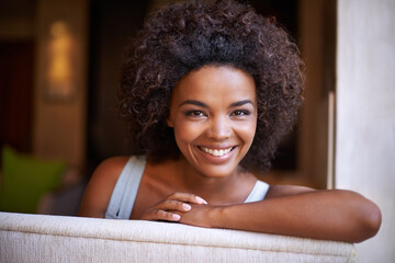 Smile, sofa and portrait of woman in living room for weekend rest, break or afternoon free time. Relax, happy and face of black female person on couch with positive mood, satisfaction and enjoyment