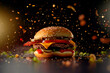 Cheeseburger with bacon and vegetables on a dark background. Explosion of flavours and textures.
