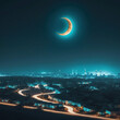Night city view with a crescent moon and the city lights.