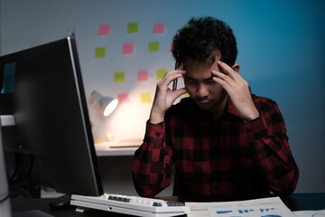 Poster - A man is sitting at a desk with a computer monitor