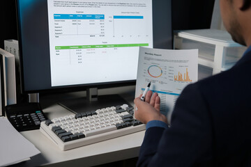 Aufkleber - A man is sitting at a desk with a computer monitor and a piece of paper