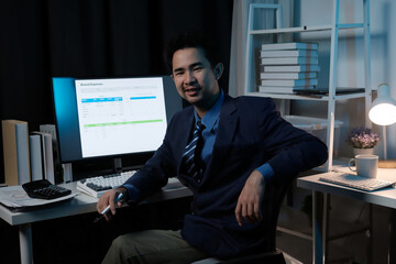Poster - A man in a suit is sitting at a desk with a computer monitor in front of him